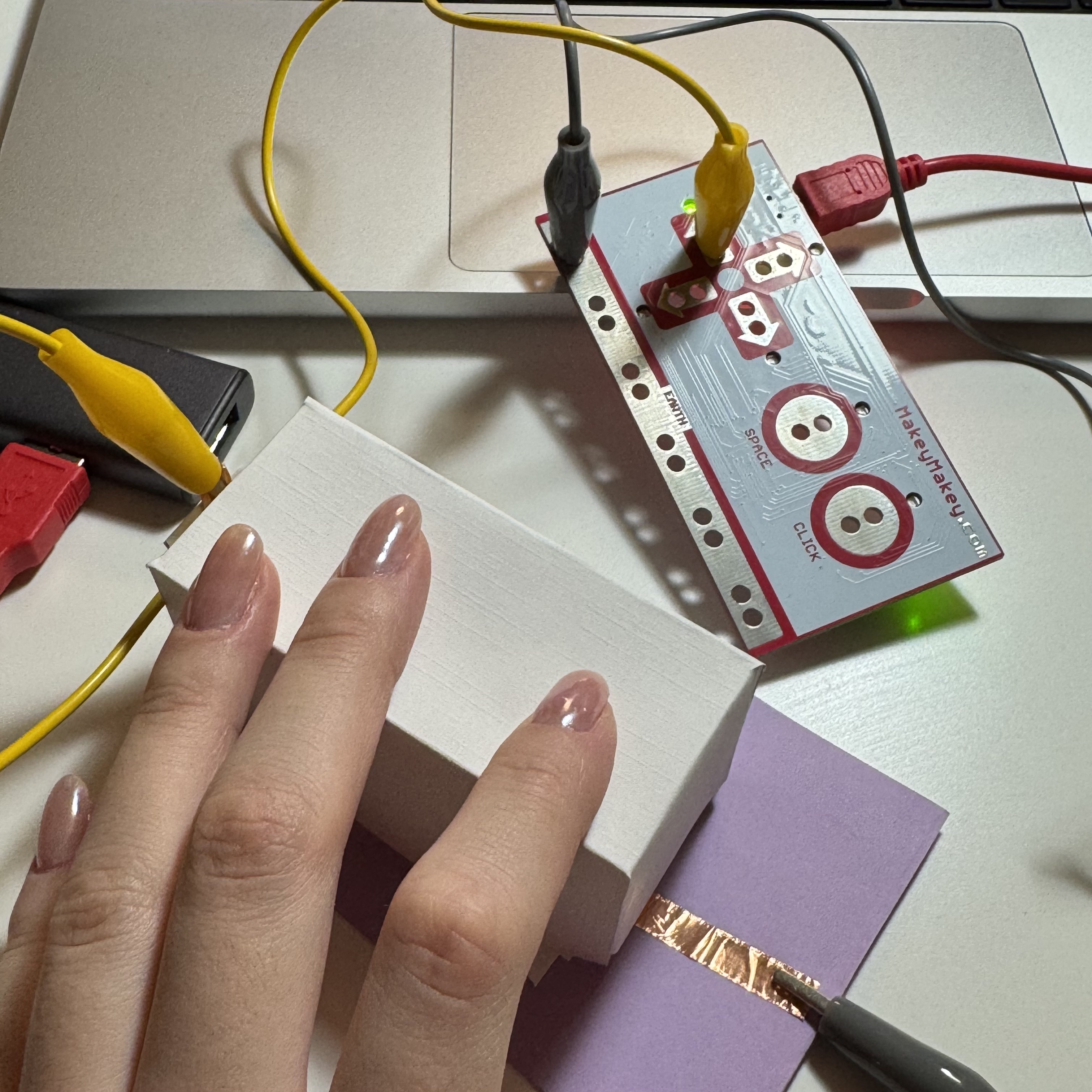 The switch was connected. The conductive tape was hidden beneath the small paper box.