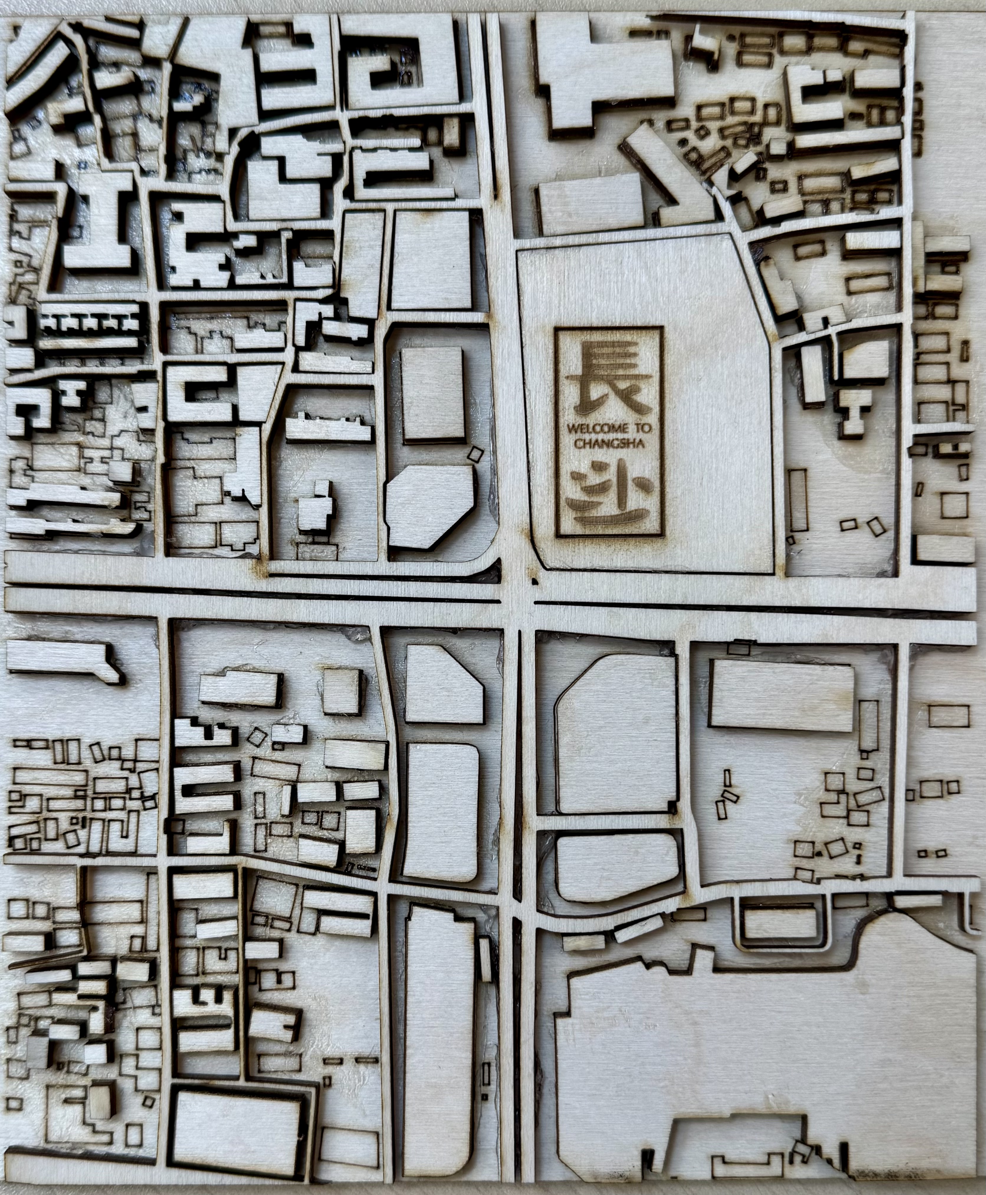 Wuyi Square is a compelling site to represent as a laser cutting map because of its rich spatial layering. The neighborhood contains dense commercial blocks, open public spaces, and complex street networks that show how the city has developed historically. I kept as many buildings as possible. I know it may seem overwhelming, but that's exactly what I want to express. This is where my hometown is so full of human warmth and development vitality.